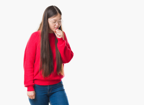 Young Chinese woman over isolated background wearing glasses feeling unwell and coughing as symptom for cold or bronchitis. Healthcare concept.