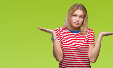 Young caucasian woman over isolated background clueless and confused expression with arms and hands raised. Doubt concept.