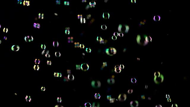 Soap bubbles are flying fast. Black Backgrounds