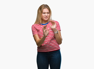 Young caucasian woman over isolated background disgusted expression, displeased and fearful doing disgust face because aversion reaction. With hands raised. Annoying concept.