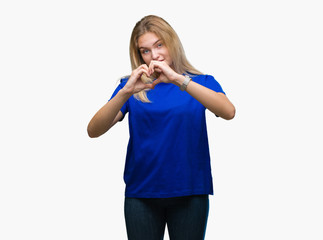 Young caucasian woman over isolated background smiling in love showing heart symbol and shape with hands. Romantic concept.