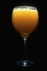 glass of wine whith juice on black background