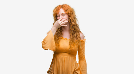 Young redhead woman smelling something stinky and disgusting, intolerable smell, holding breath with fingers on nose. Bad smells concept.