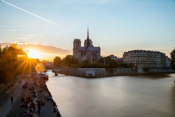 Cathedral of Notre Dame de Paris with Seine river at sunset. Paris, France.
