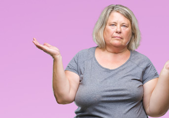 Senior plus size caucasian woman over isolated background clueless and confused expression with arms and hands raised. Doubt concept.