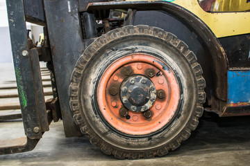The front wheels of the forklift.