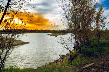 The river on the background of the September blue-orange sky