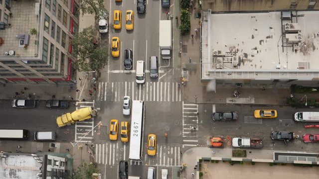 A top down bird's eye view of a typical midtown Manhattan intersection as traffic and pedestrians travel on the streets below. Day/night matching available.  	