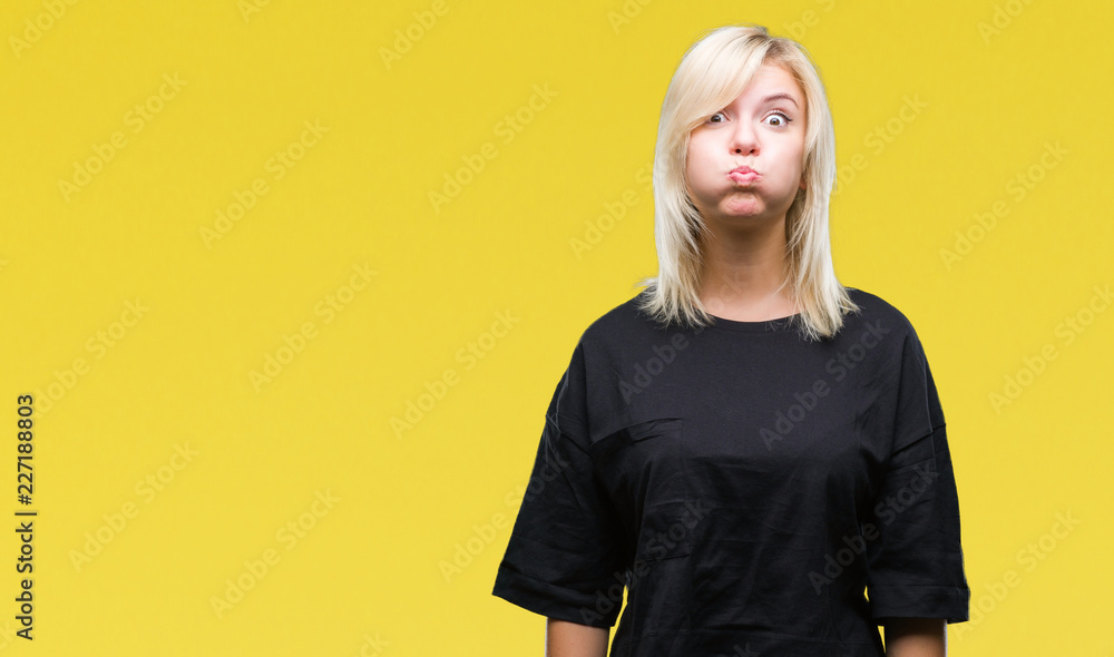 Poster young beautiful blonde woman over isolated background puffing cheeks with funny face. mouth inflated