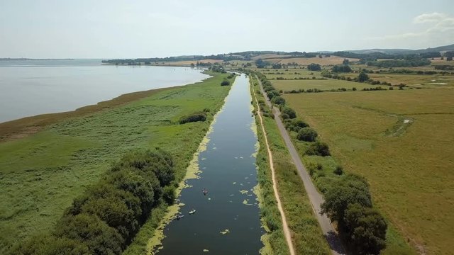 Flying Over Sunny Canal next to River Exe in Devon - 4K Aerial Footage