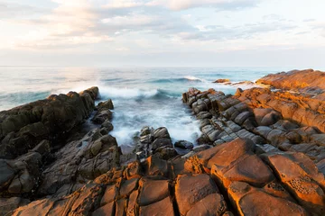 Fototapeten Sunrise on coast of sea © Charlie