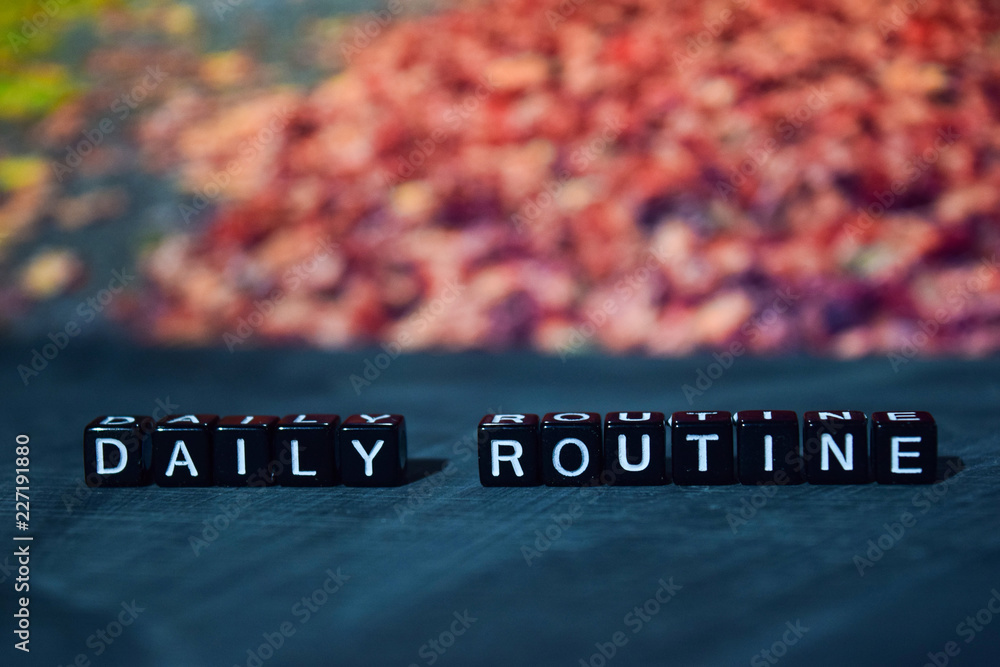 Fototapete daily routine on wooden blocks. cross processed image with bokeh background