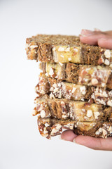 Woman hand with slice of banana bread on white space.