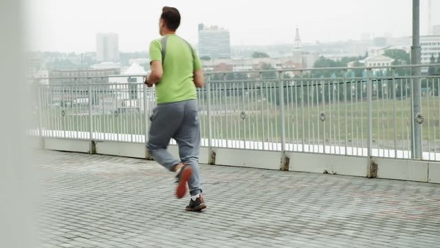 Young athlete runner in the city super slow motion