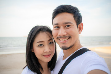 Romantic couple take selfie photo on the beach.