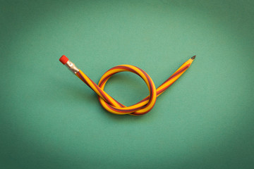 Flexible pencil . Isolated on light background. Bending pencil