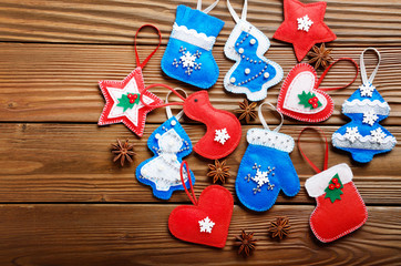 Handmade rustic felt Christmas tree decorations with anise on wooden table