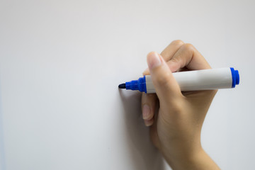 Someone writing on the whiteboard with blue pen