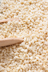 Heap of sesame seeds on wooden boards