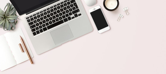 modern header / hero image or banner with laptop computer, smartphone, air plant, open notebook and feminine accessories on a bright blush background, home office scene, flat lay / top view - obrazy, fototapety, plakaty