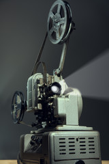 Cinema projector with a film on dark background