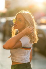 Blond girl on white T shirt walking Hollywood Blvd on sunset
