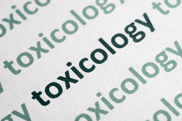 word toxicology printed on paper macro