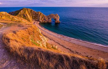 Sunset over Durdle Door - the most famous landmark in Devon England