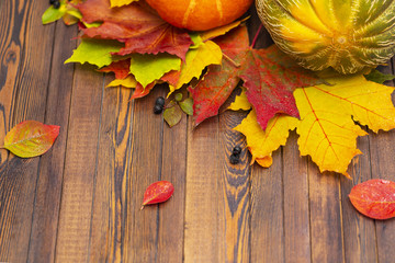Naklejka na ściany i meble Thanksgiving background. Autumn vegetables, berries and leaves on a wooden Board. The concept of thanksgiving.