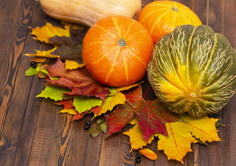 Thanksgiving background. Autumn vegetables, berries and leaves on a wooden Board. The concept of thanksgiving.