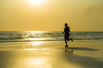 silhouette of young happy and attractive African American runner woman exercising in running...