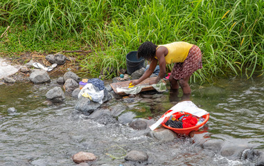 Villager washing clothes in the river. Travel to Sao Tome and Principe. Beautiful paradise island...