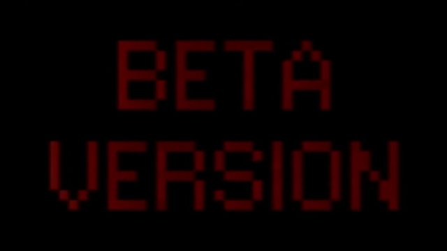 Analog VHS tape distortion: a flashing text with the words Beta Version. Red on black, blocky 8-bit characters, faded color tone.
