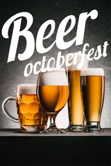 mugs of beer on grey background with "beer octoberfest" lettering
