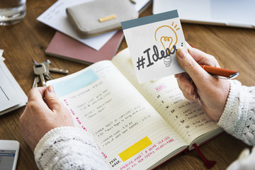 Hand holding hashtag Ideas on a sticky note