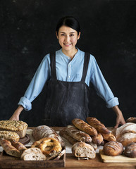 Japanese baker with an assortment of fresh bread