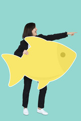 Businesswoman holding a big fish