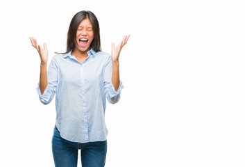 Young asian business woman over isolated background celebrating mad and crazy for success with arms...