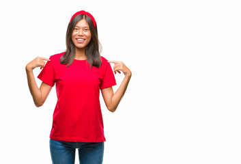 Young asian woman over isolated background looking confident with smile on face, pointing oneself...