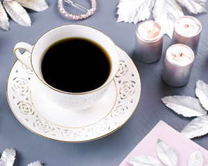 Winter concept flat lay with coffee drink and silver leaves, copy space