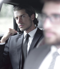 business people sitting in car