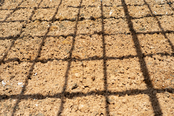 Abstract background and texture of .lateritic soil with the shadow of steel structure on the ground at construction site