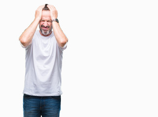 Middle age hoary senior man wearing white t-shirt over isolated background suffering from headache desperate and stressed because pain and migraine. Hands on head.