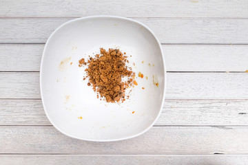 Pouring brown sugar into mixing bowl with ingredients for making cookies