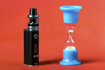 still life of vape and hourglass, concept smoking takes time