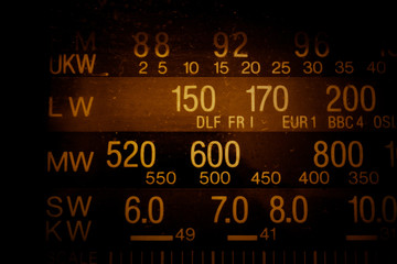 Radio scale, frequency, frequency range, tuner, spoiled film, vintage filter abstract texture background. Medium waves, long waves, short waves, portable radio, radio transmitter, FM.
