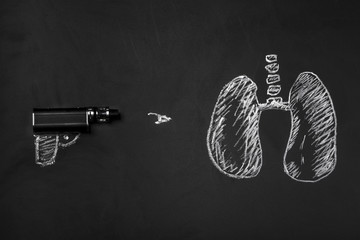 electronic cigarette and lungs on a blackboard, concept smoking kills