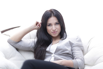 young woman sitting in a comfortable soft big armchair