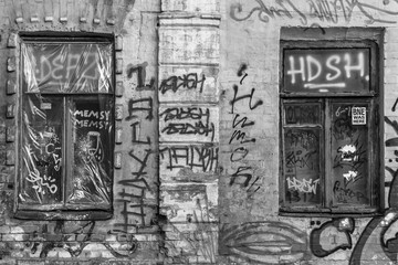 Graffiti on the walls of the old house. Street art. The painted facade of an abandoned house. Urban style. Dysfunctional area of a large European city.