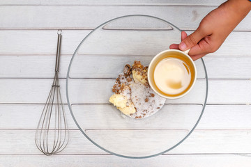 An Asean handsome teen boy pouring  cooking oil for making famous amous. Food and cooking concept.